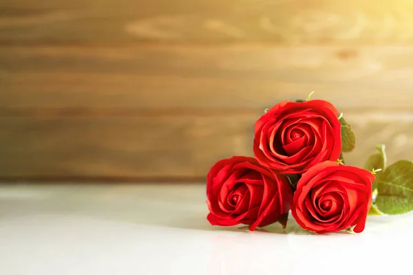 Röda rosor på bordet med kopieringsutrymme — Stockfoto