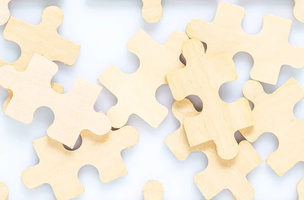 Shot of wooden jigsaw puzzle pieces on white background,Business concept