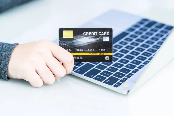 Close up of female hands making online payment, Woman hands holding a credit card and using laptop for online shopping