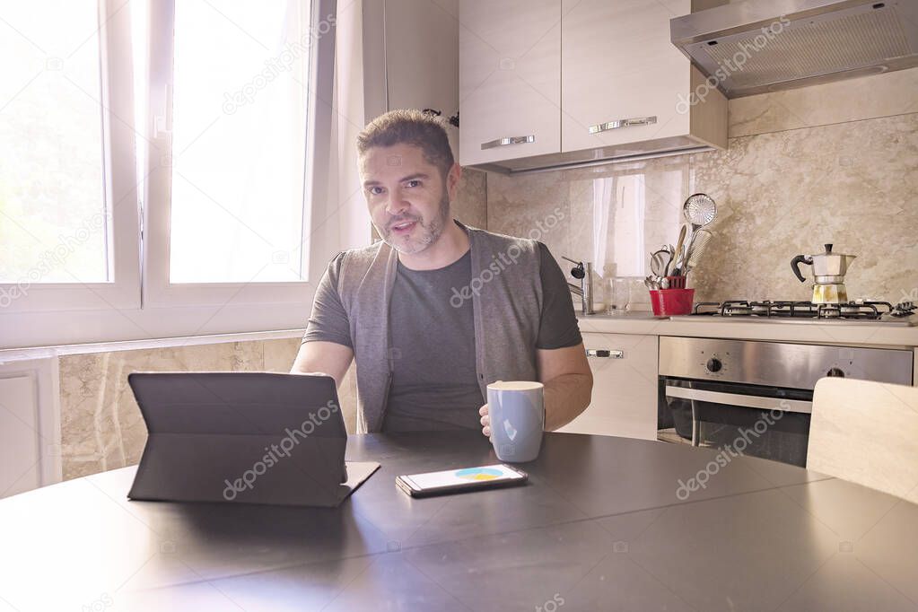 young man works with the tablet from home