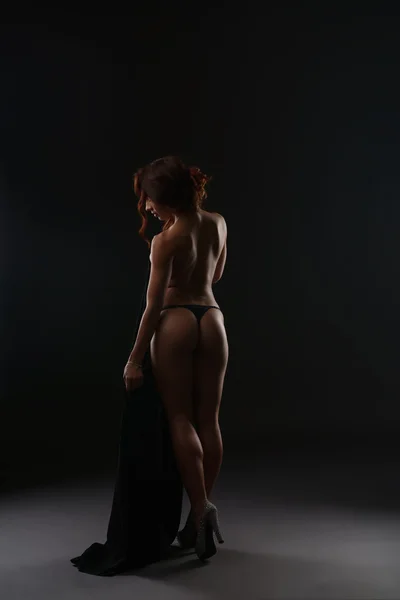 Rear view of slender red-haired woman in thong — Stock Photo, Image