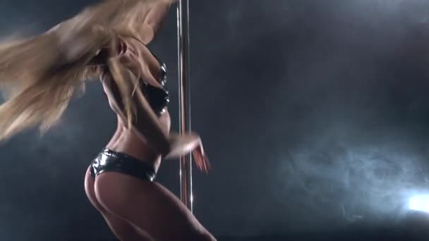 Pole dance. View of sexy girl dancing passionately