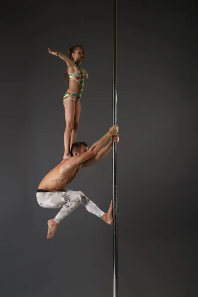 Casal de acrobatas performirg no estúdio de dança pólo — Fotografia de Stock