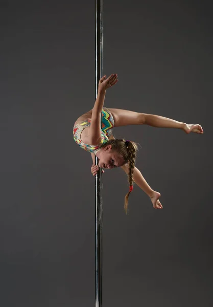 Junior girl balancing on pylon at dance studio — Stock Photo, Image