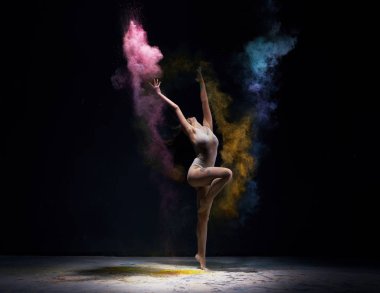 Gymnast in ecru bodysuit with colored dust around clipart