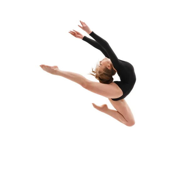 Young slim gymnast in gracefull jump studio shot — Stock Photo, Image