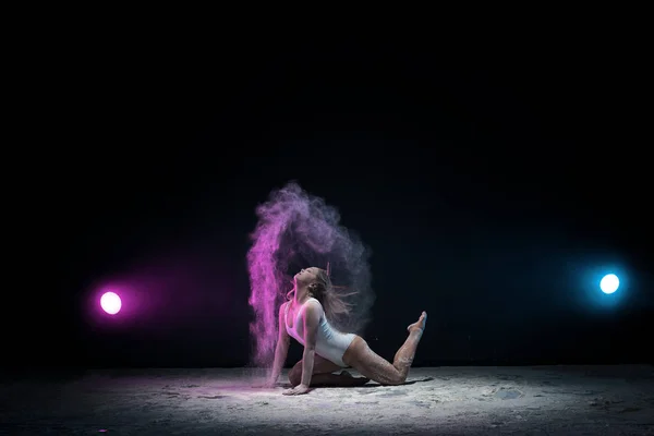 스튜디오에 있는 컬러 먼지구름 속에서 포즈를 취하는 날씬 한 소녀 — 스톡 사진