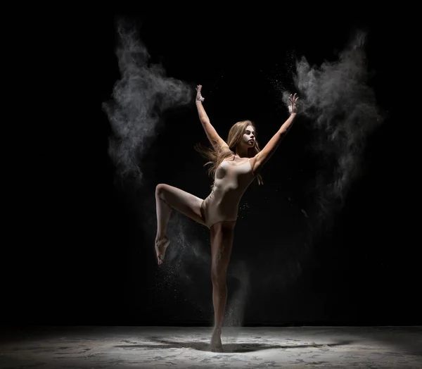 Beautiful blonde dancing in cloud of white dust — Stock Photo, Image