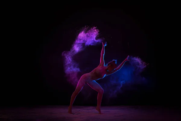 Graceful girl dancing in color powder cloud — Stock Photo, Image