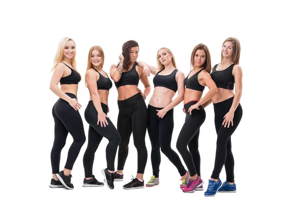 Young fitness trainers in black tops and leggings — Stock Photo, Image