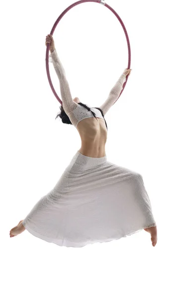 Pretty brunette perfoming aerial exercise on hoop — Stock Photo, Image