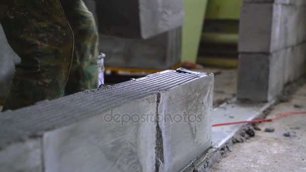 Arbeiter baut eine Wand aus Porenbeton-Blöcken — Stockvideo