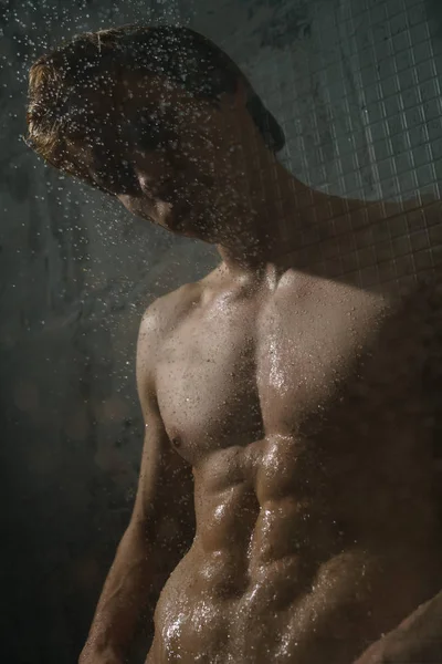 Nude young man taking shower studio portrait — Stock Photo, Image