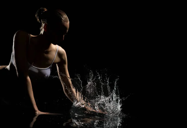 Sexy blonde enjoying water splashes in dark studio — Stock Photo, Image