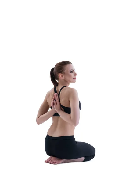 Yuong meisje doet yoga poseren met de rug naar viewer — Stockfoto