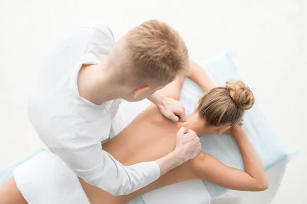 Top view of massagyst massaging pretty blonde — Stock Photo, Image