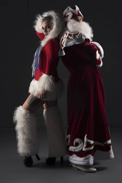 Young sexy Snow Maiden with her Santa Clause shot — Stock Photo, Image