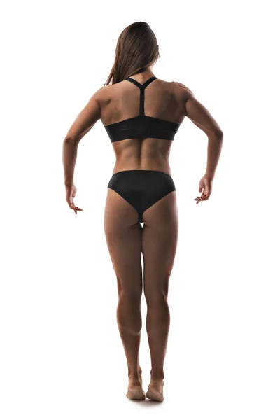 Muscular fisiculturista feminino isolado retrovisor — Fotografia de Stock