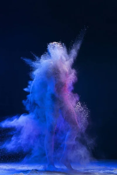 Figura masculina tiro totalmente em uma nuvem de poeira azul — Fotografia de Stock