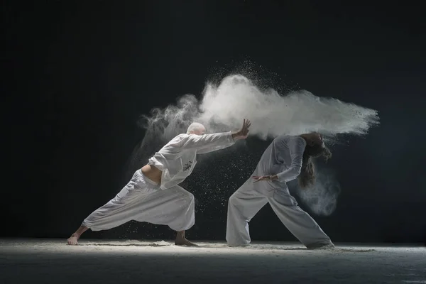 Two men doing yoga in white dust cloud view — Stock Photo, Image