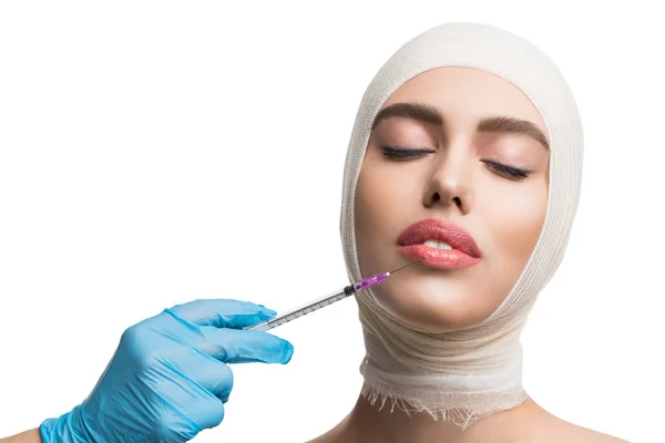 Woman her head bandaged getting lips injections — Stock Photo, Image