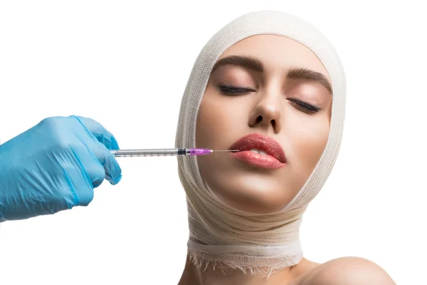Girl her head bandaged getting lips injections — Stock Photo, Image
