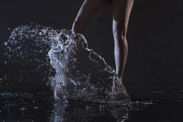 Barefoot woman dancing in water in the dark — Stock Photo, Image