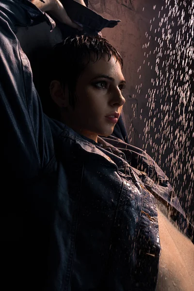 Brunett i blöta jeans skjorta i dusch i mörkret — Stockfoto