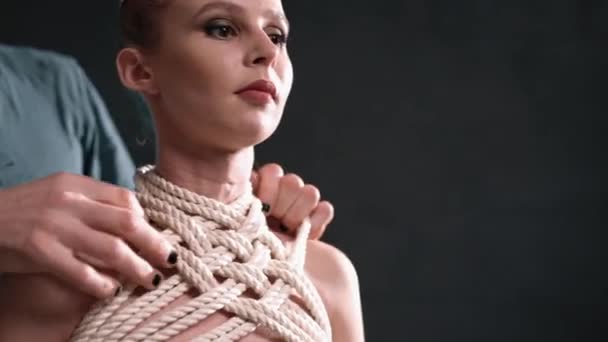 Shibari macho mestre amarrando corda na vista loira nua — Vídeo de Stock