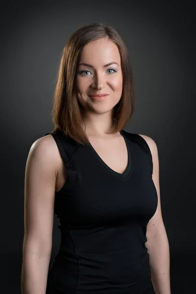 Pretty slim fitness trainer posing in studio — Stock Photo, Image