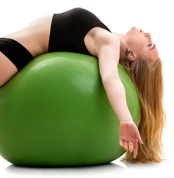 Female gymnast lying on back on green big fitball — Stock Photo, Image