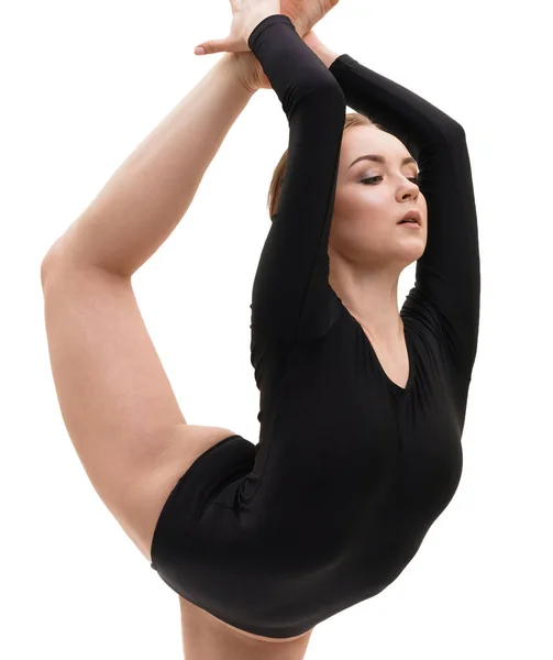 Joven gimnasta rubia en negro haciendo ejercicio en el estudio —  Fotos de Stock
