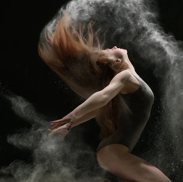 Sexy girl in a cloud of white dust studio portrait — Stock Photo, Image