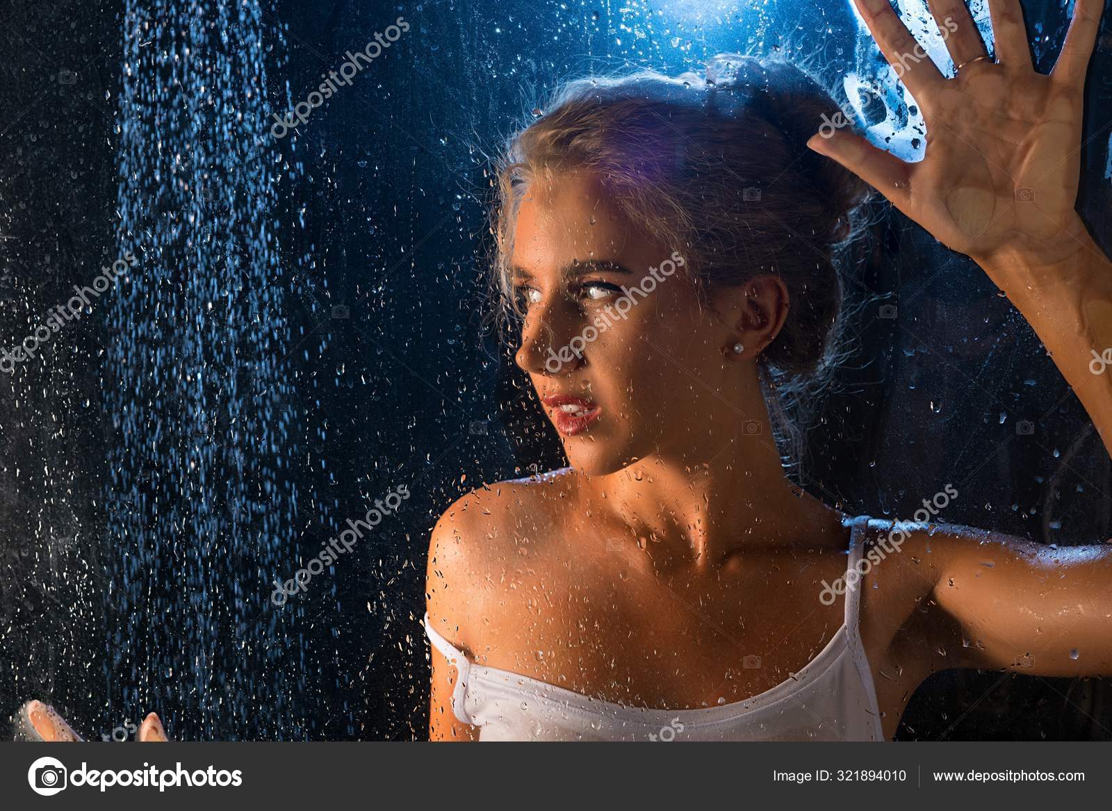 Girl in tshirt having shower portrait in the dark Stock Photo by