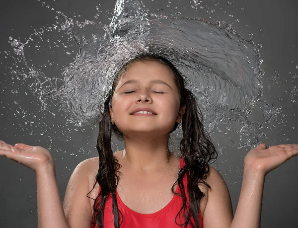Young girl catching water stream from top — Stock Photo, Image