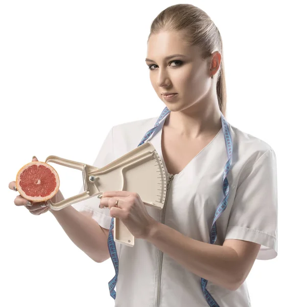 Nutritionist in white uniform with a tape-measure — Stock Photo, Image