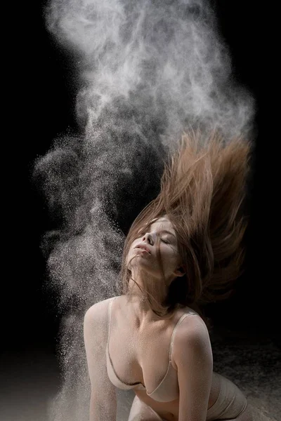 Sexy girl in underwear in white dust cloud — Stock Photo, Image