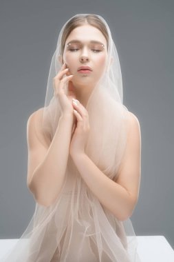 Pretty woman in bra and white veil cropped view