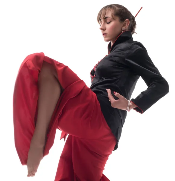 Woman in chinese clothes practicing wushu shot — Stock Photo, Image