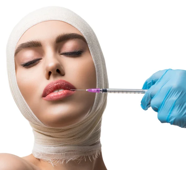 Girl her head bandaged getting lips injections — Stock Photo, Image