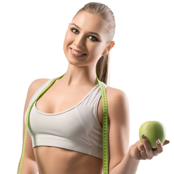 Fitnesstrainer met een appel en een lintmeter — Stockfoto