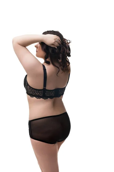 Fat brunette in black lingerie isolated rearview — Stock Photo, Image