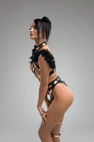 Slim girl in bdsm style gold underwear shot — Stock Photo, Image