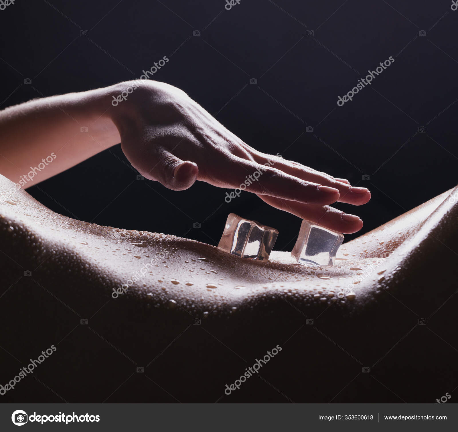 Ice cubes lying on woman body cropped view Stock Photo by ©Wisky 353600618
