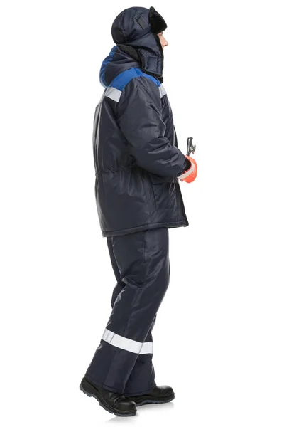 Male model in protective warm suit with hat and wrench in hands in studio — Stock Photo, Image