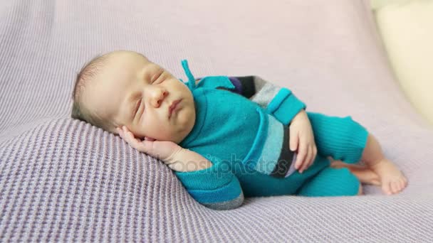 Kid in blue costume, sleeping on side — Stock Video