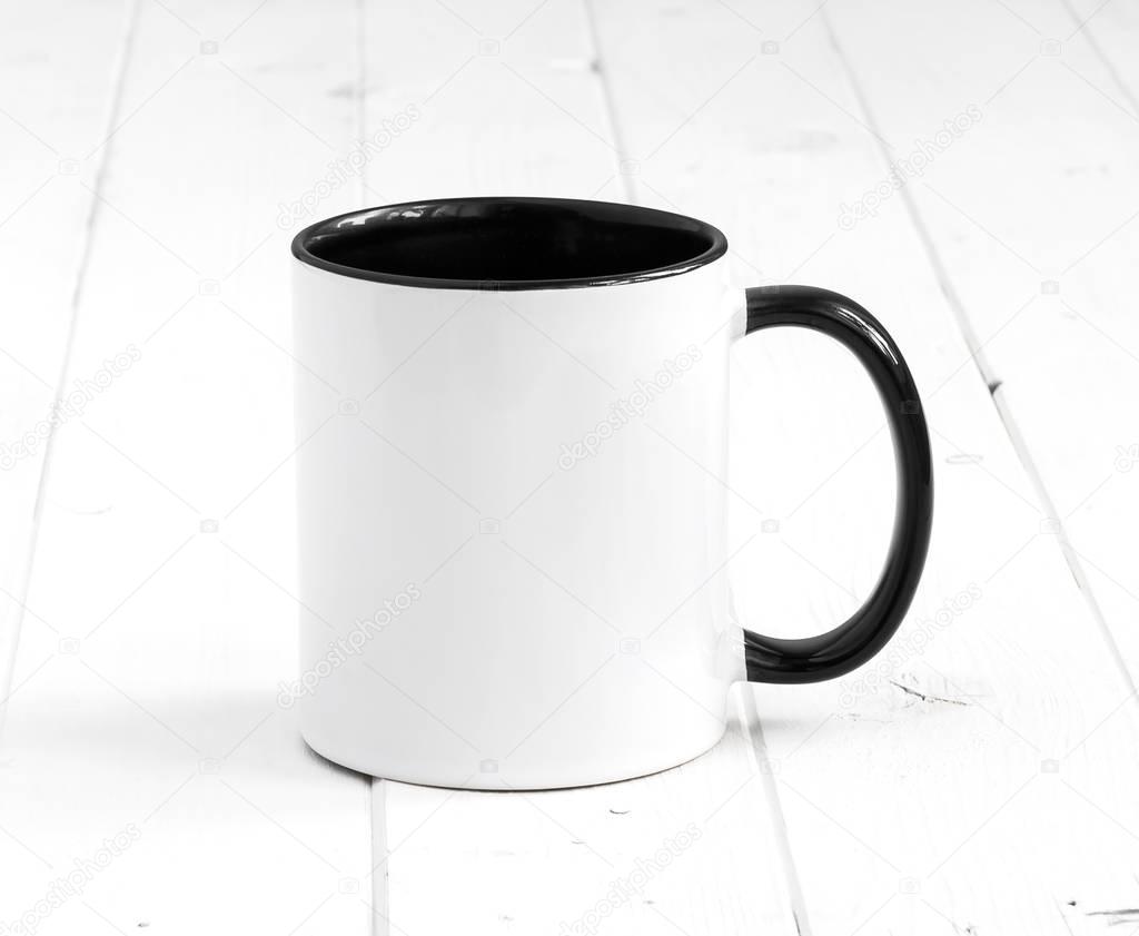 white cup with dark black inside on a table