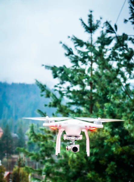 Flying white quadrocopter — Stock Photo, Image