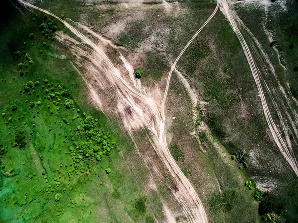 Aerial photo of green field with trees and rolled roads — Stock Photo, Image