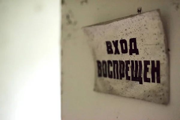 Стены с пилинговой краской и табличкой в заброшенной школе в Припяти — стоковое фото